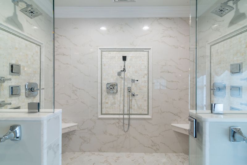 A bathroom with a walk in shower and a sink.