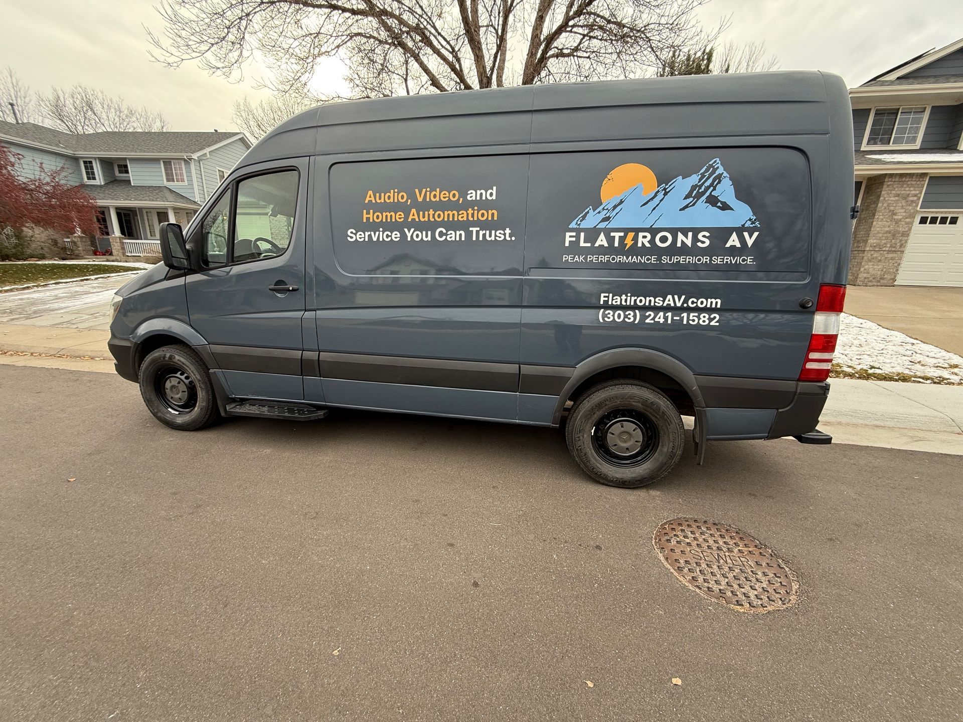 Dark gray van with logo 