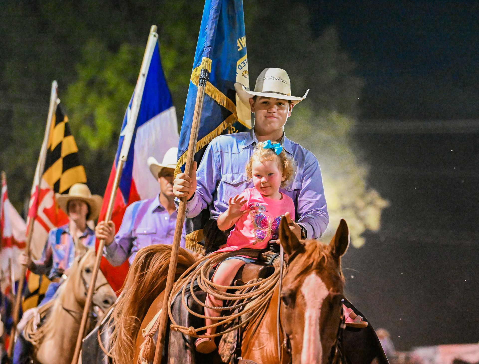A man is carrying a little girl on his back while riding a horse.