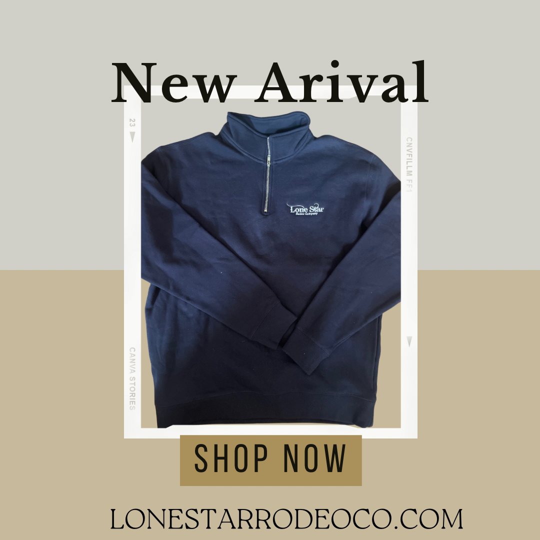 Two shirts are hanging on a fence at sunset.