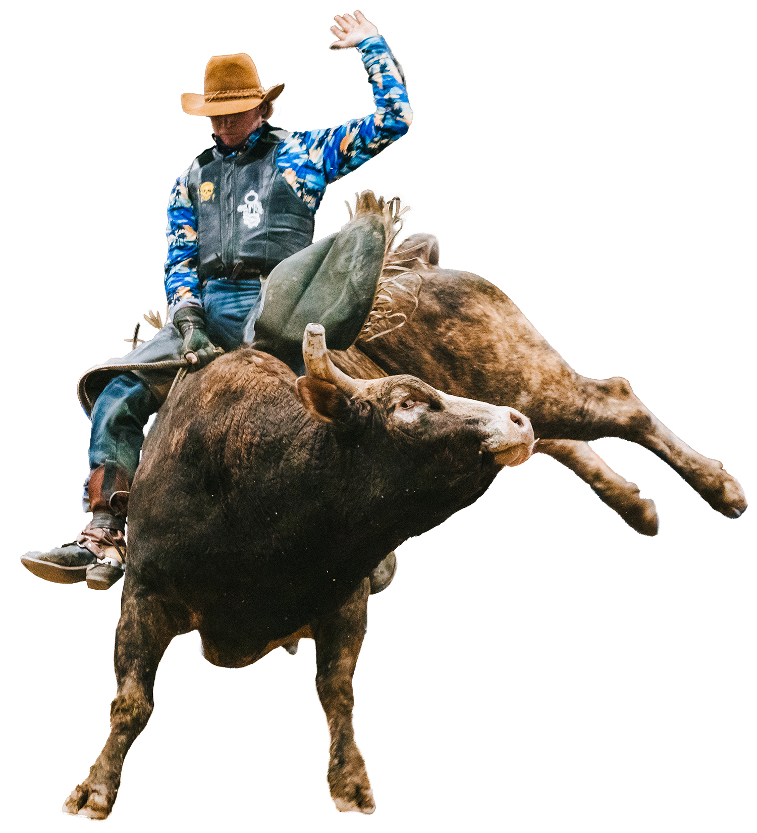 A man in a cowboy hat is riding a bull