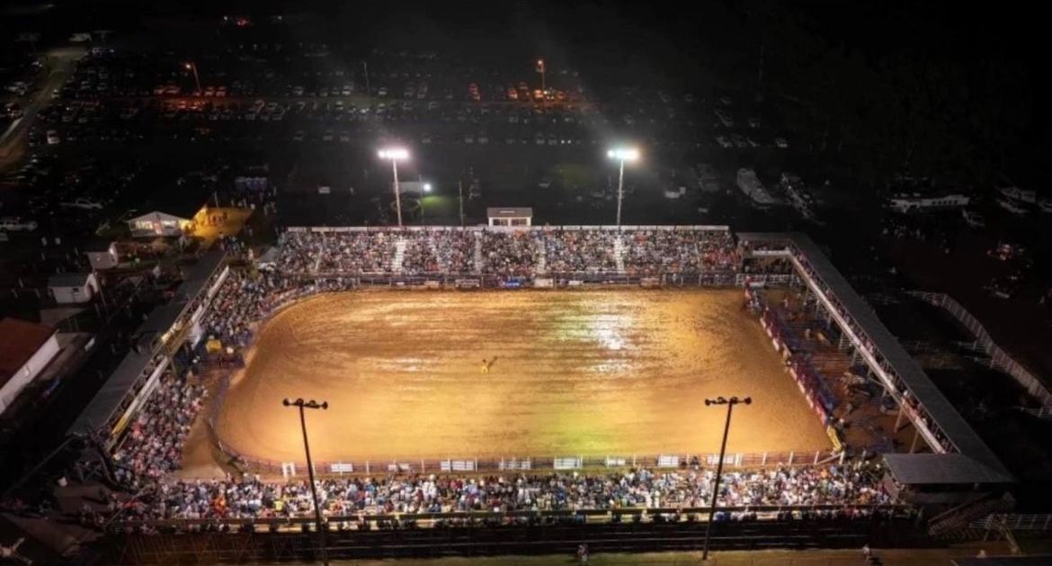 An aerial view of a rodeo arena at night.