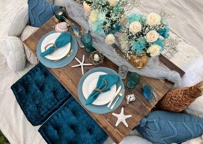 A blue themed luxury picnic set up at the beach - A Posh Unicorn Luxury Picnic in San Diego