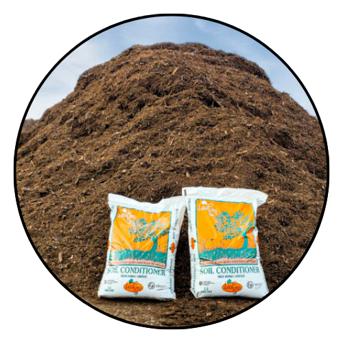 Pile of Leafgro soil conditioner with two bags in front.