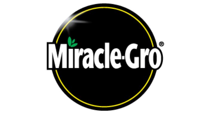 Miracle-Gro logo: white text on a black circle with a green leaf design and yellow outline.