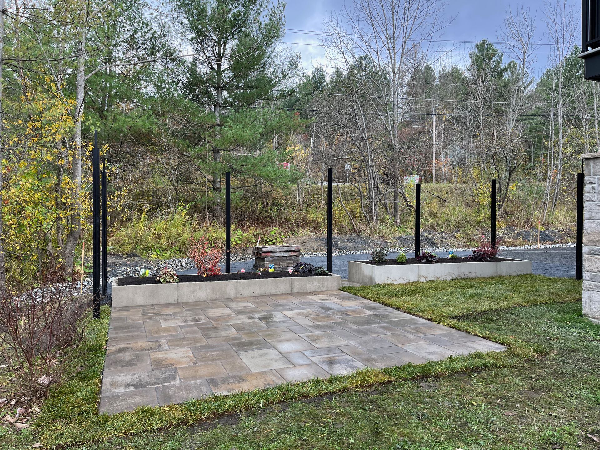 Un patio avec une clôture et des arbres en arrière-plan.