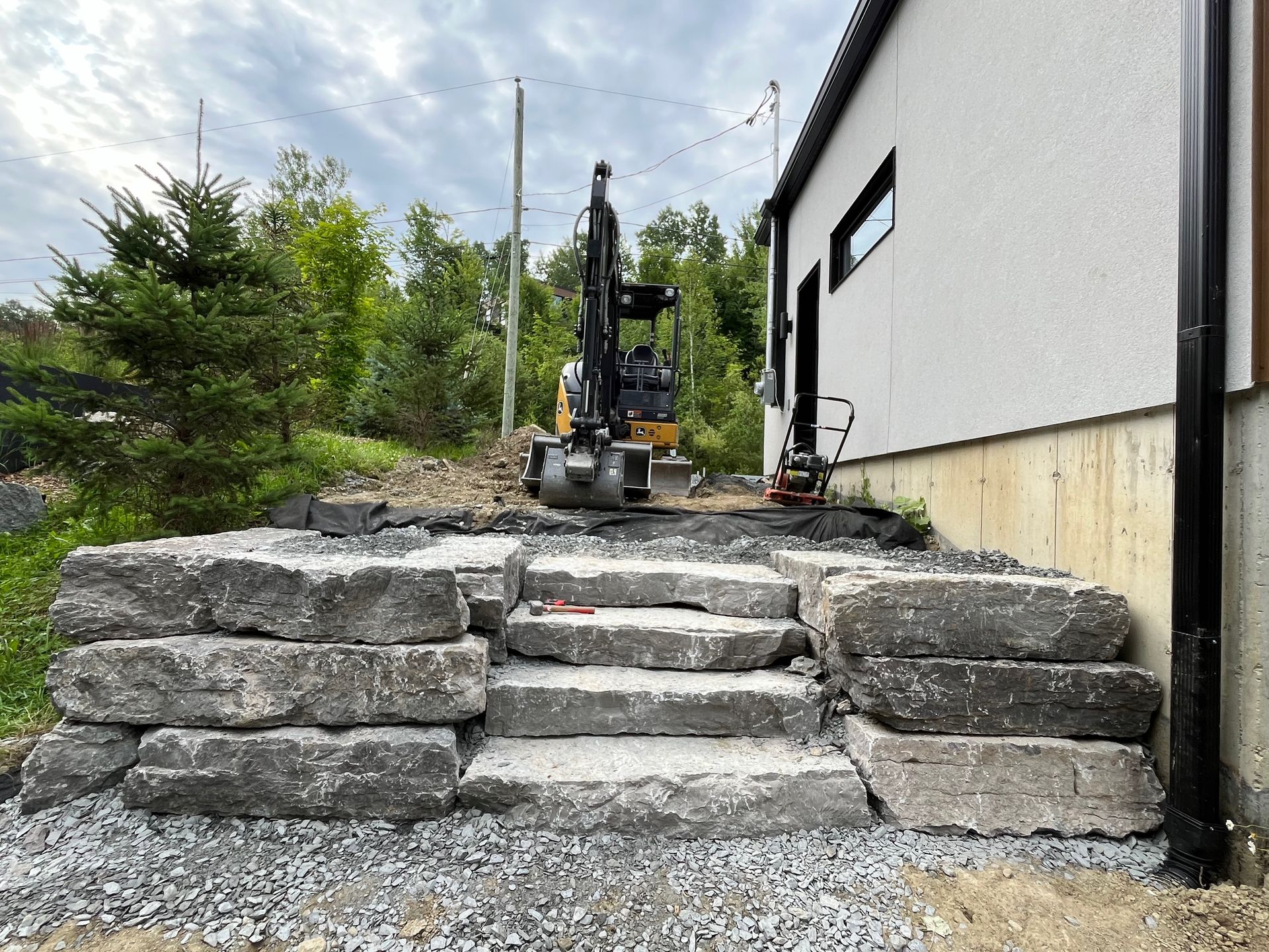 Un gros tas de pierres se trouve devant une maison.