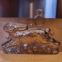 Silver metal mold of a running rabbit.