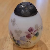 White frosted glass salt shaker with floral design, black metal lid.