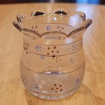 Clear glass vase with decorative gold and blue painted accents.