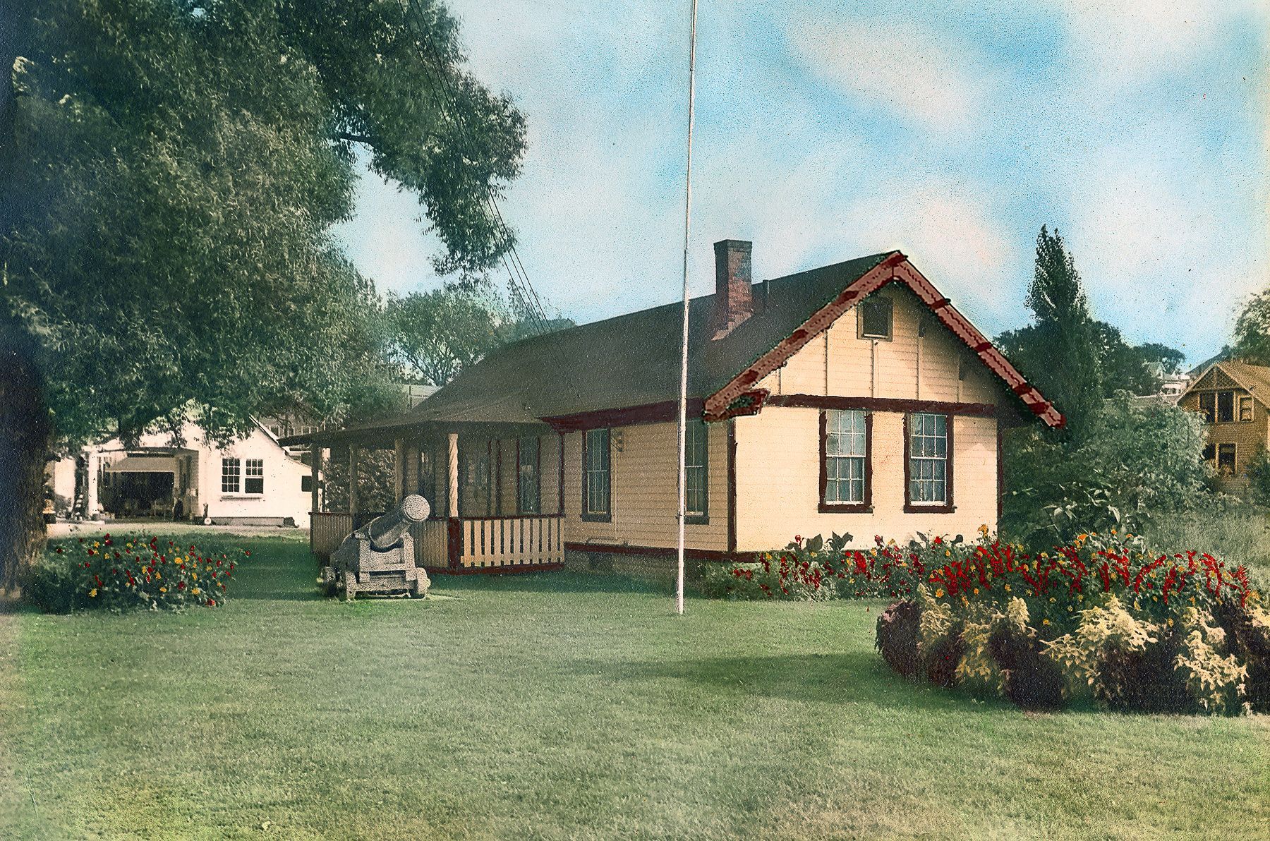 A small house with a flag pole in front of it