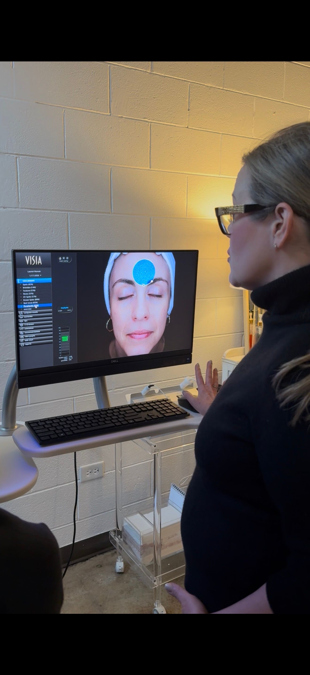 A woman with long blonde hair is wearing a ponytail.