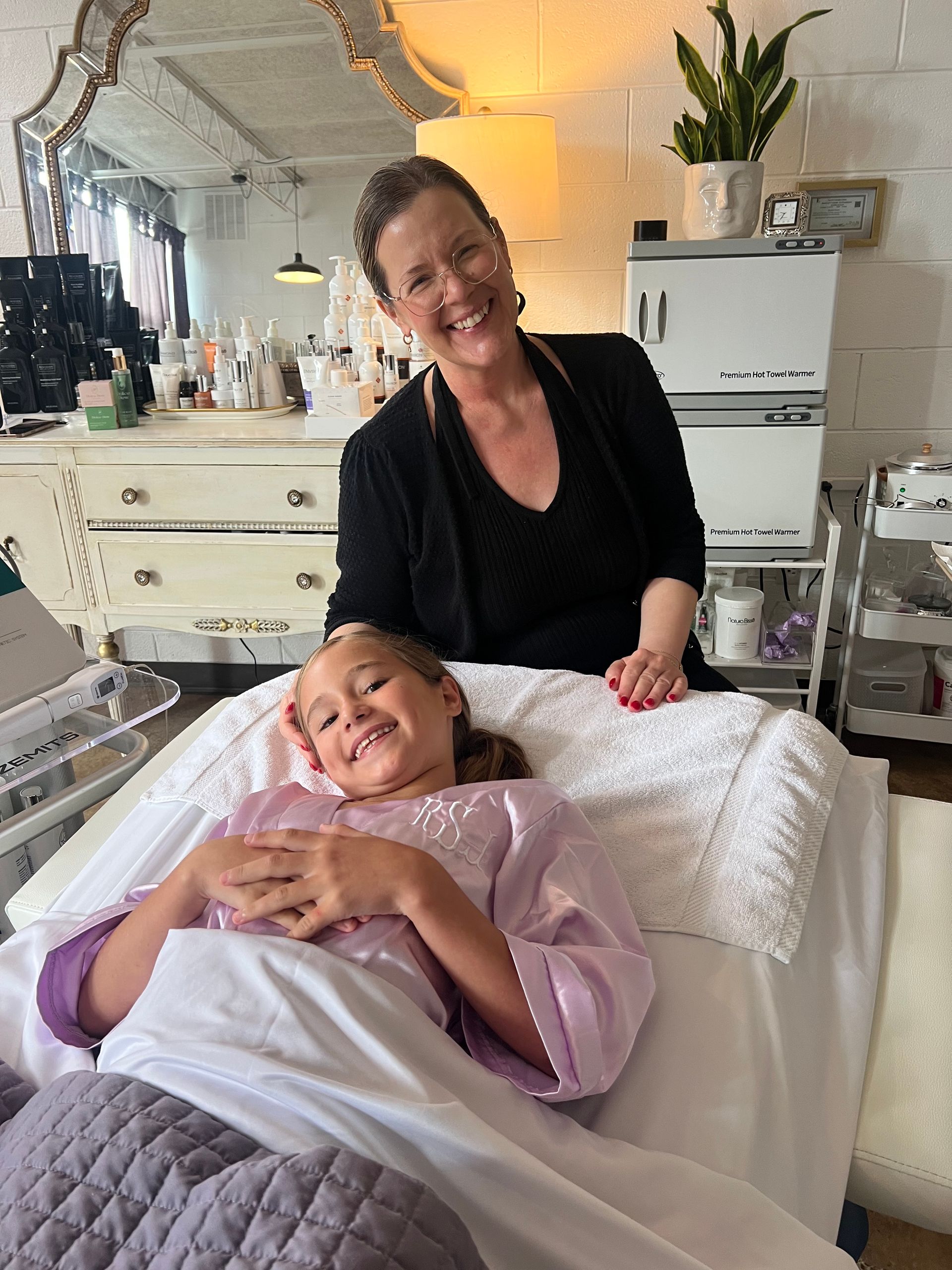 A woman with short red hair is wearing a white tank top