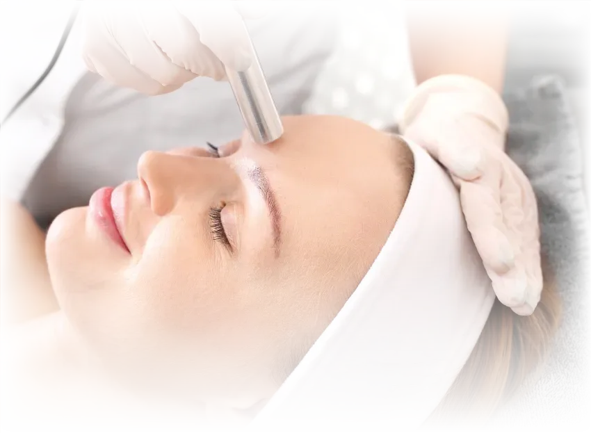 A woman is getting an electro-current facial with TRIAWAVE device