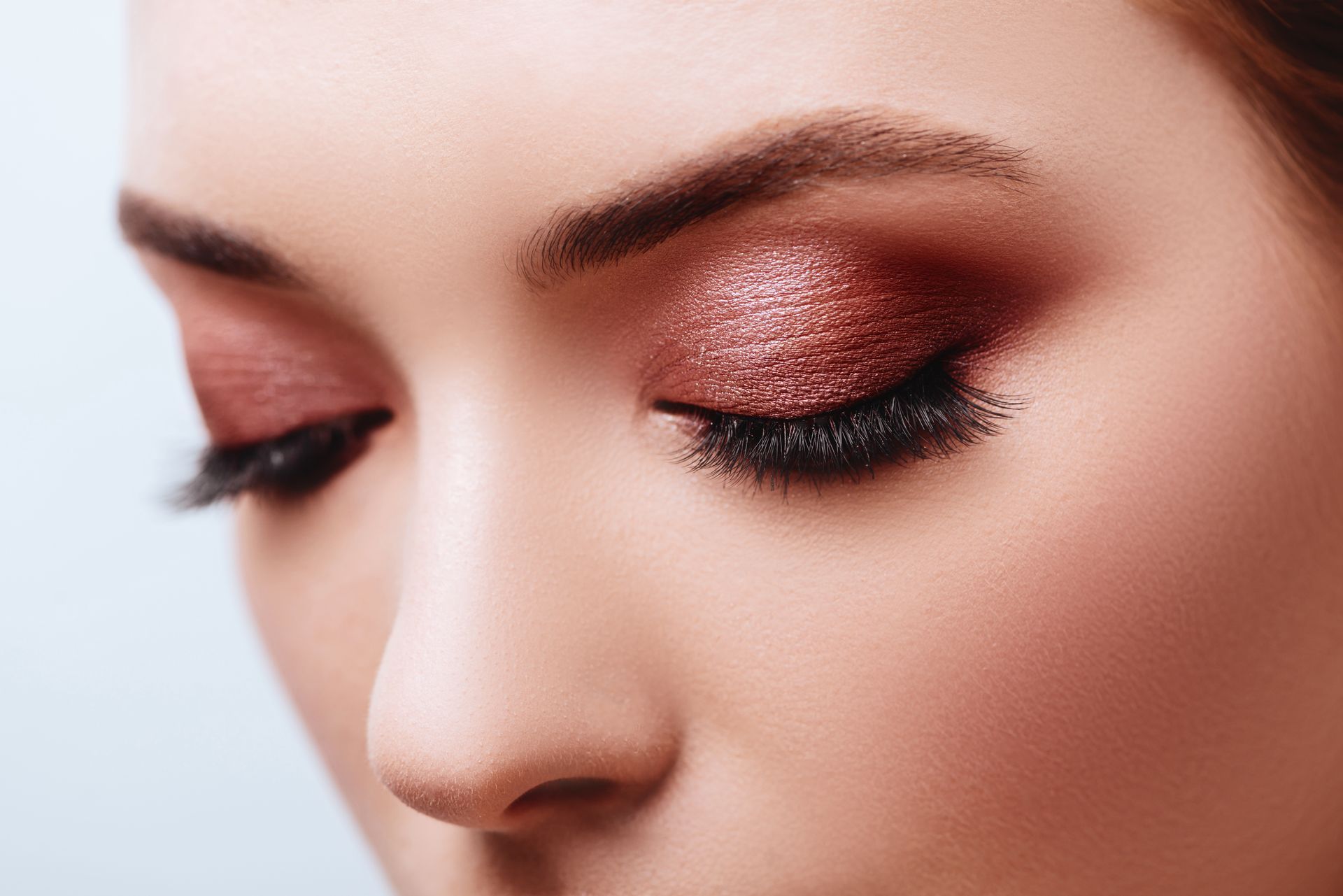 A close up of a woman 's face with makeup on her eyes.