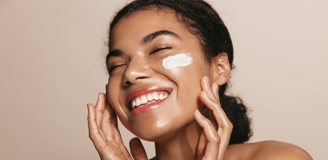 A woman is getting a head massage with her eyes closed.