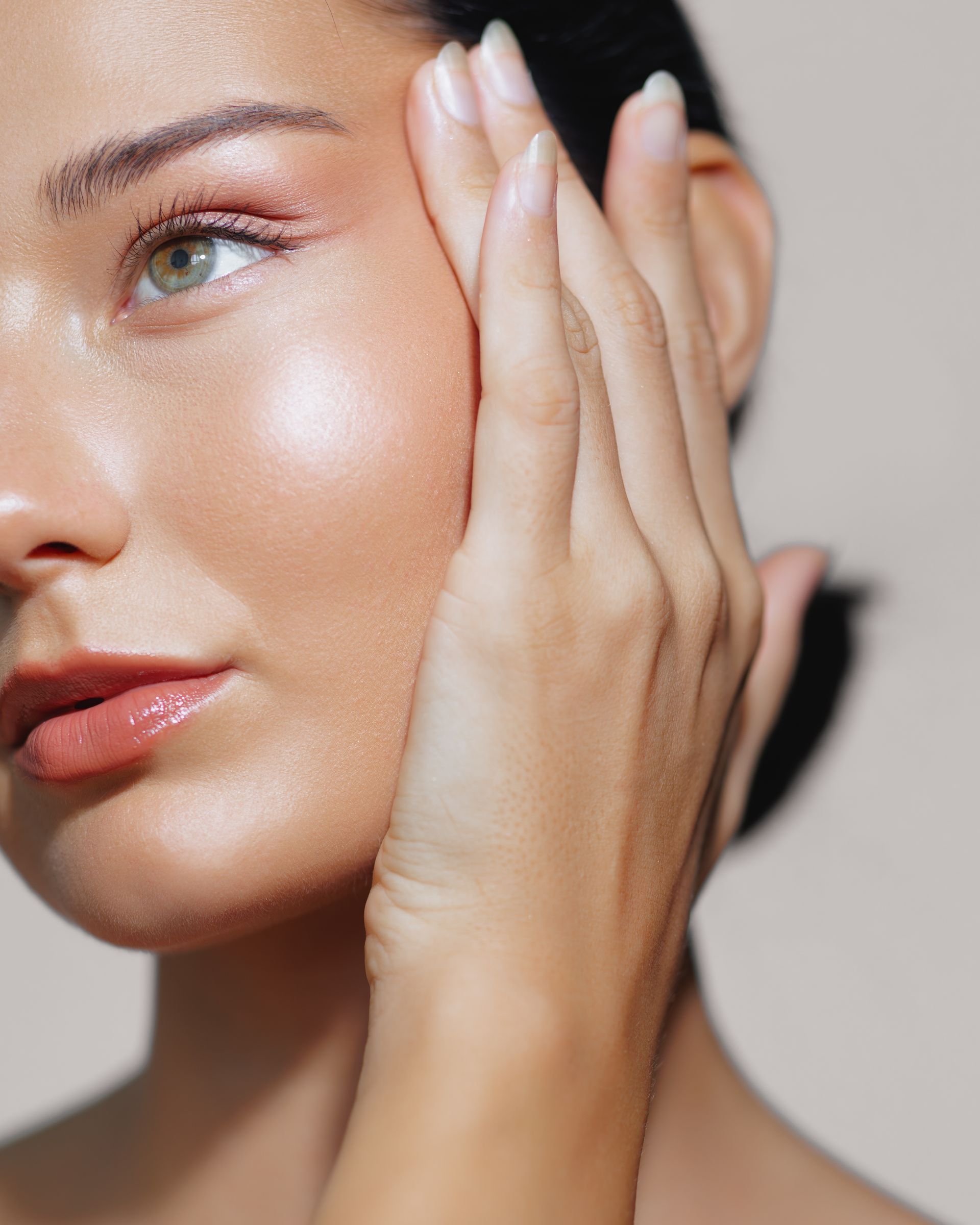 A close up of a woman 's face with her hand on it