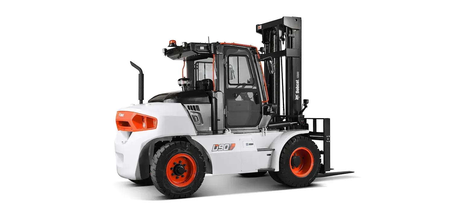 A forklift is sitting on a white surface.