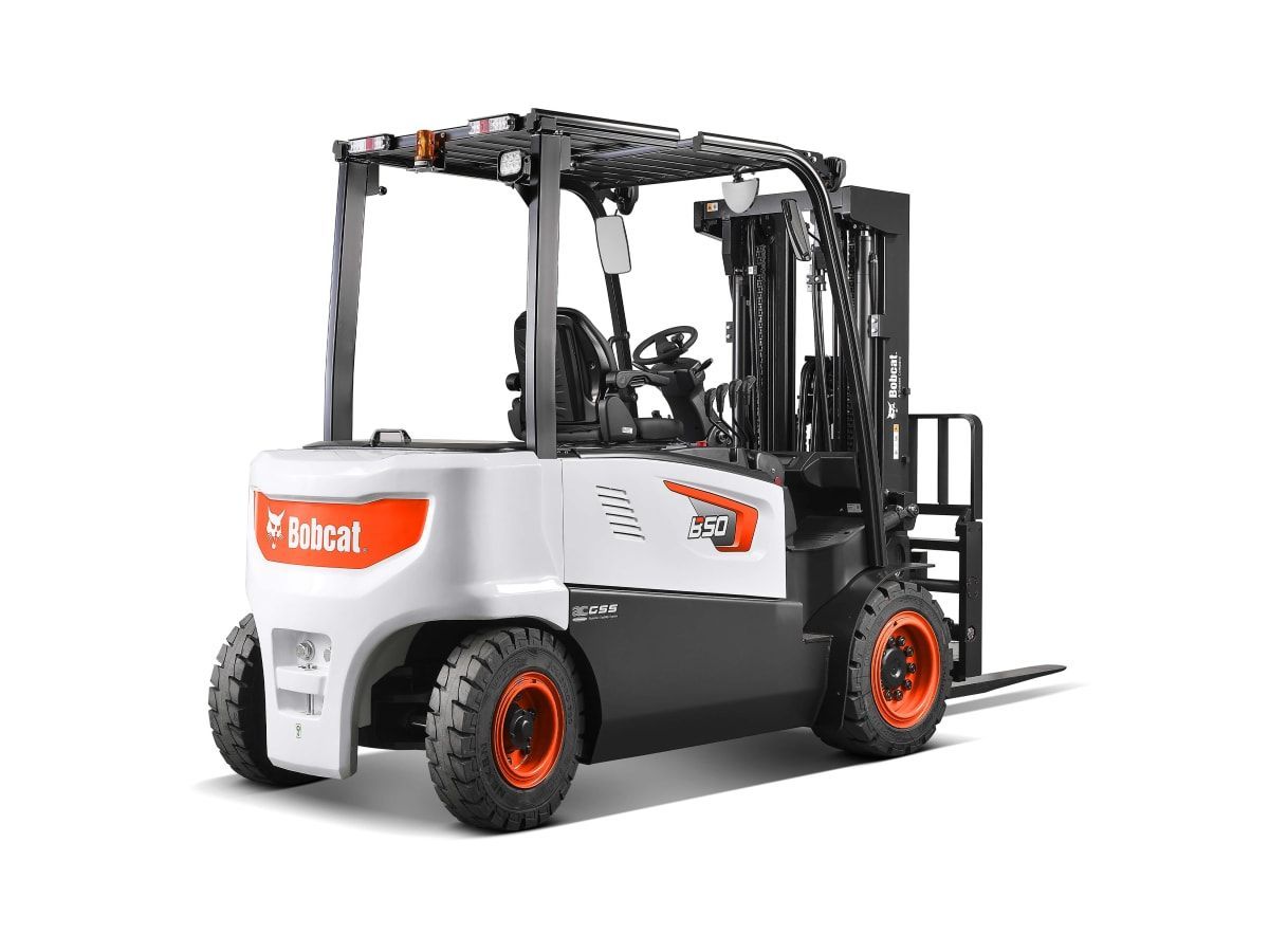 A forklift is sitting on a white surface.