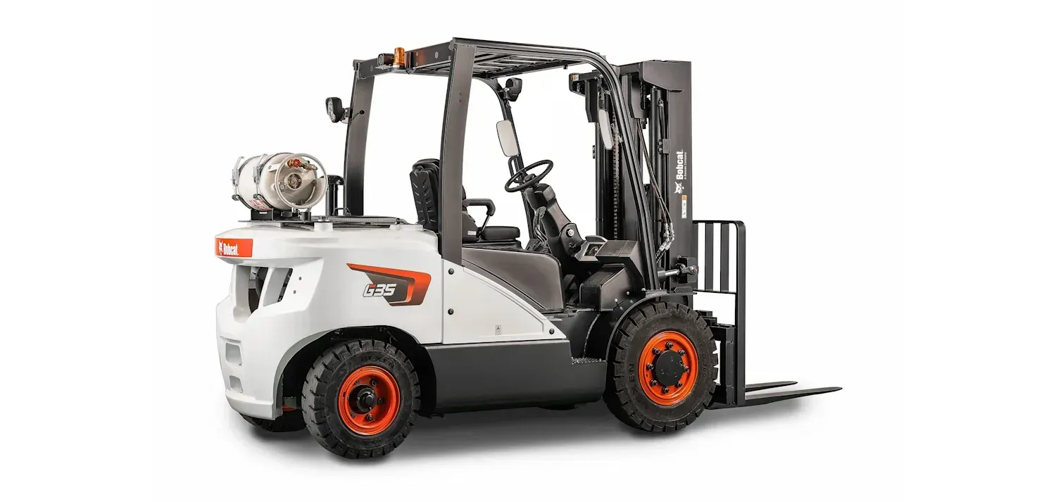 A forklift is sitting on a white surface.
