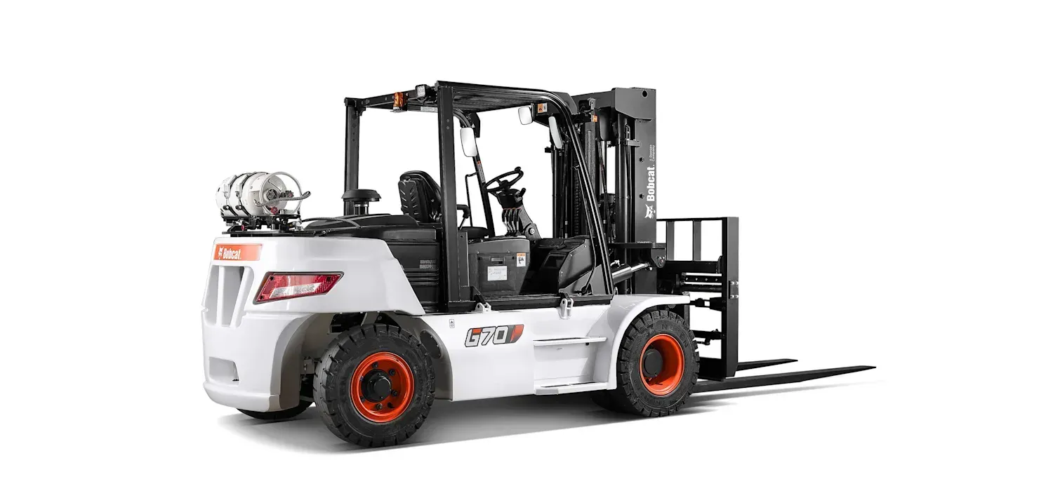 A forklift is sitting on a white surface.