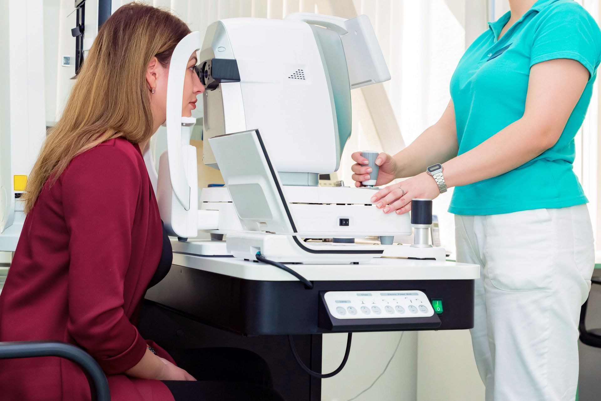 A woman is getting her eyes checked by an ophthalmologist.