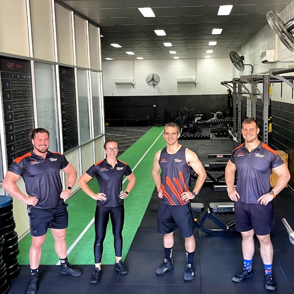 Four Groups Of People Are Posing For A Picture In A Gym — Ultimate Results Training in Aitkenvale, QLD