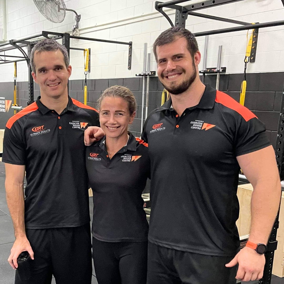 A Group Of Seven People Are Sitting On A Bench In A Gym — Ultimate Results Training in Aitkenvale, QLD