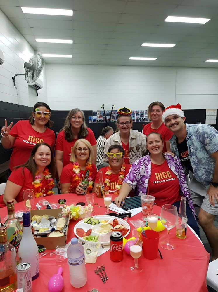 Seven Groups Of People Are Posing For A Picture At A Table — Ultimate Results Training in Aitkenvale, QLD