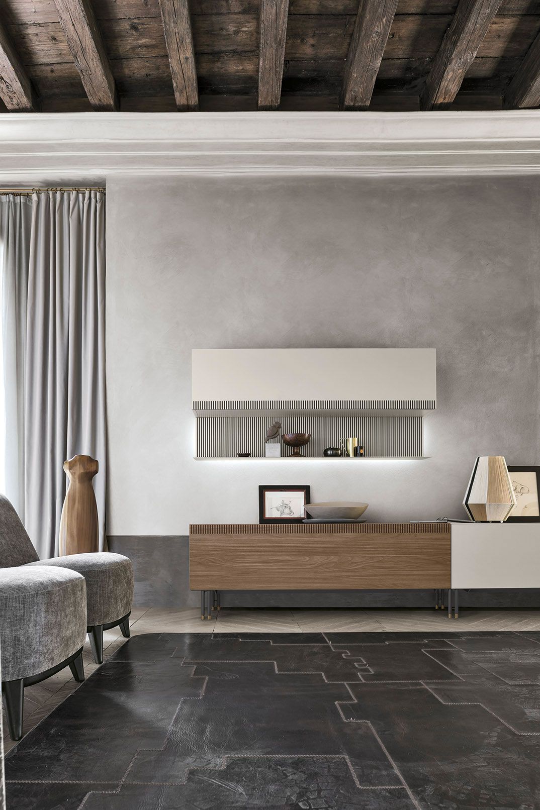 Un soggiorno con soffitto in legno e mobile porta TV in legno.