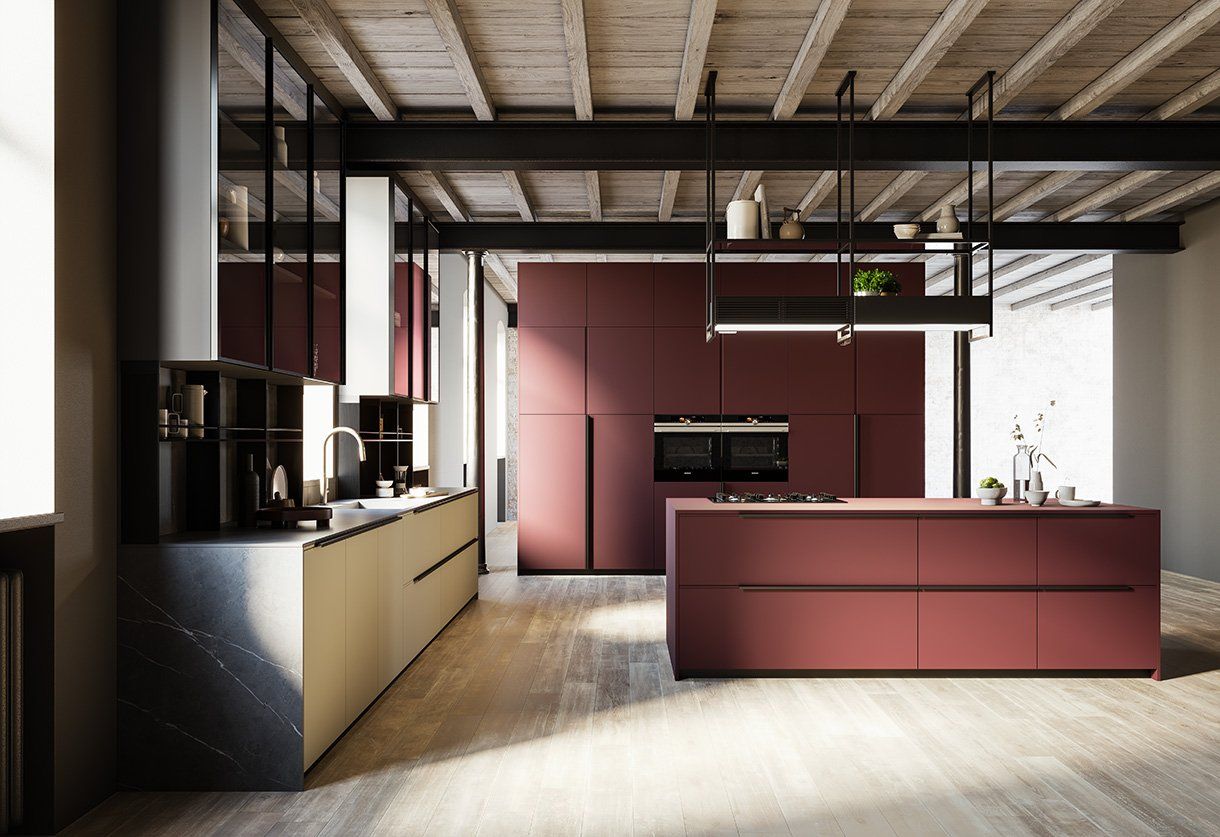 Una cucina con mobili rossi e una grande isola al centro