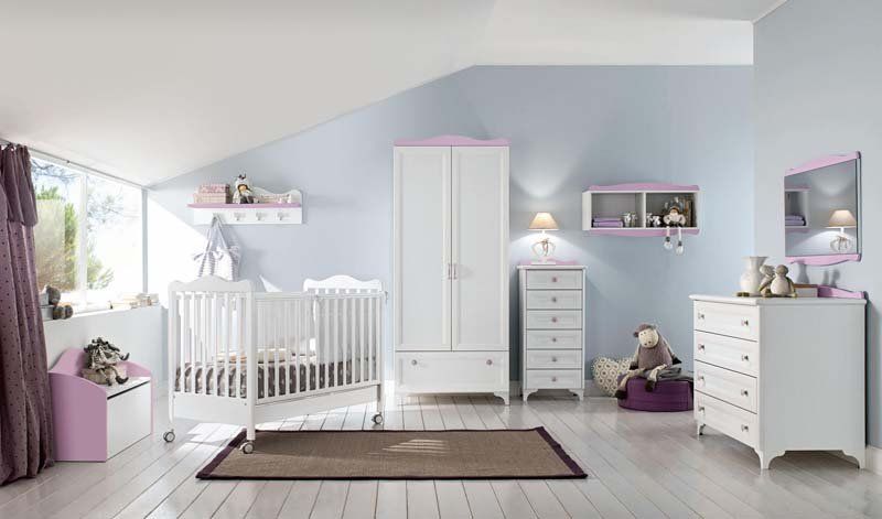Una stanza per neonati con culla, cassettiera e armadio
