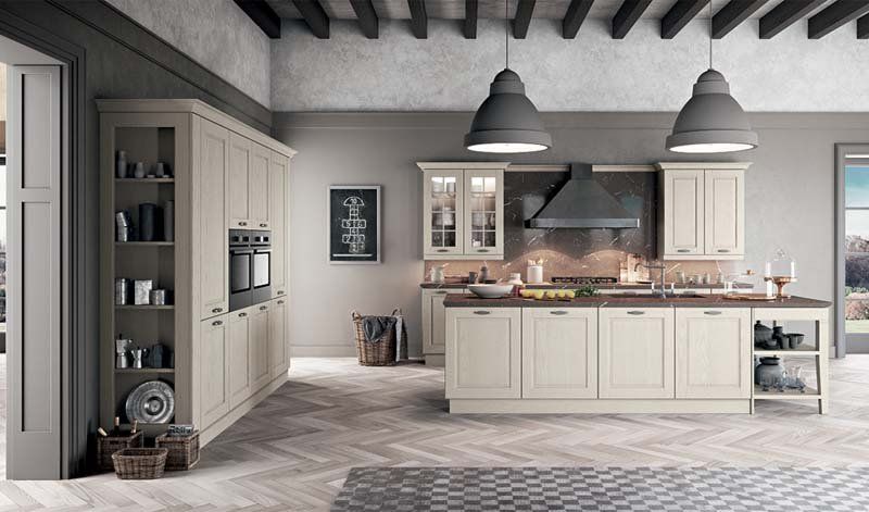 Una cucina con mobili bianchi e una grande isola al centro della stanza.