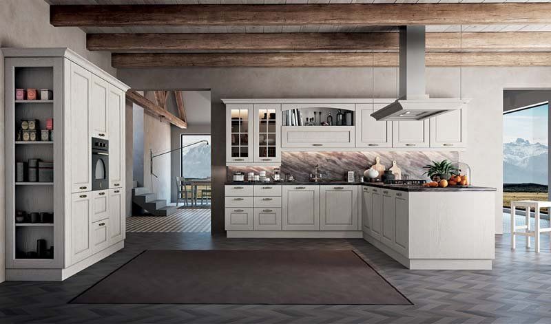 Una cucina con mobili bianchi e un piano cottura con forno.