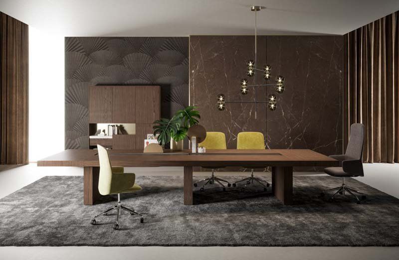 Una sala conferenze con un lungo tavolo di legno e sedie.