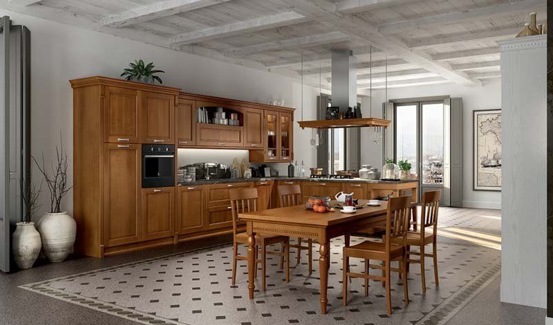 Una cucina con mobili in legno, un tavolo e sedie.