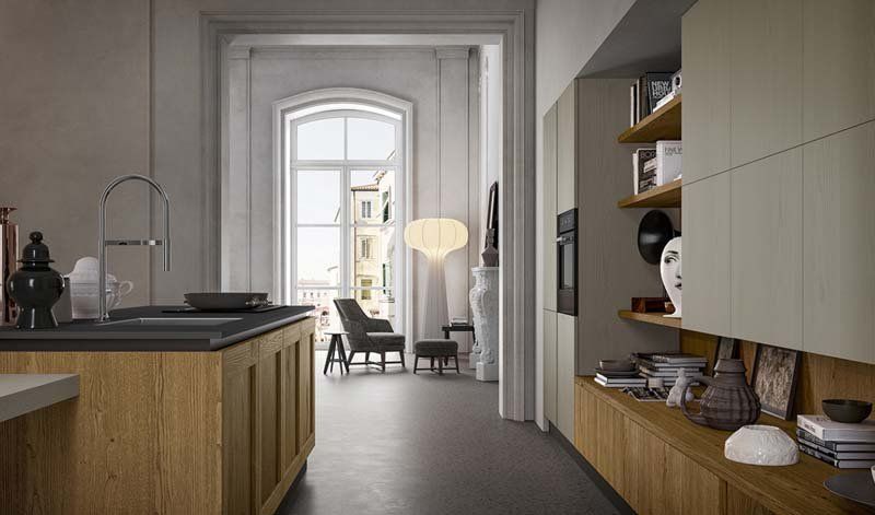 Una cucina con mobili in legno e una grande isola al centro della stanza.