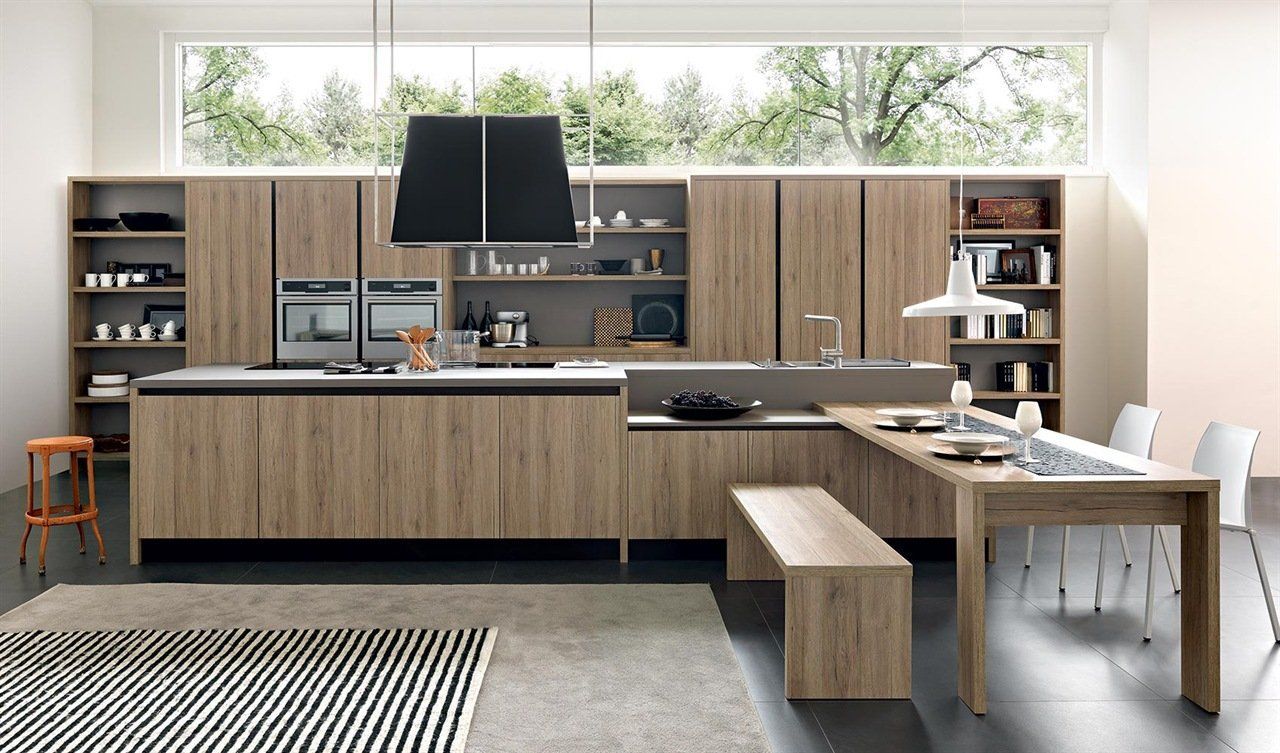 Una cucina con mobili in legno e una grande finestra