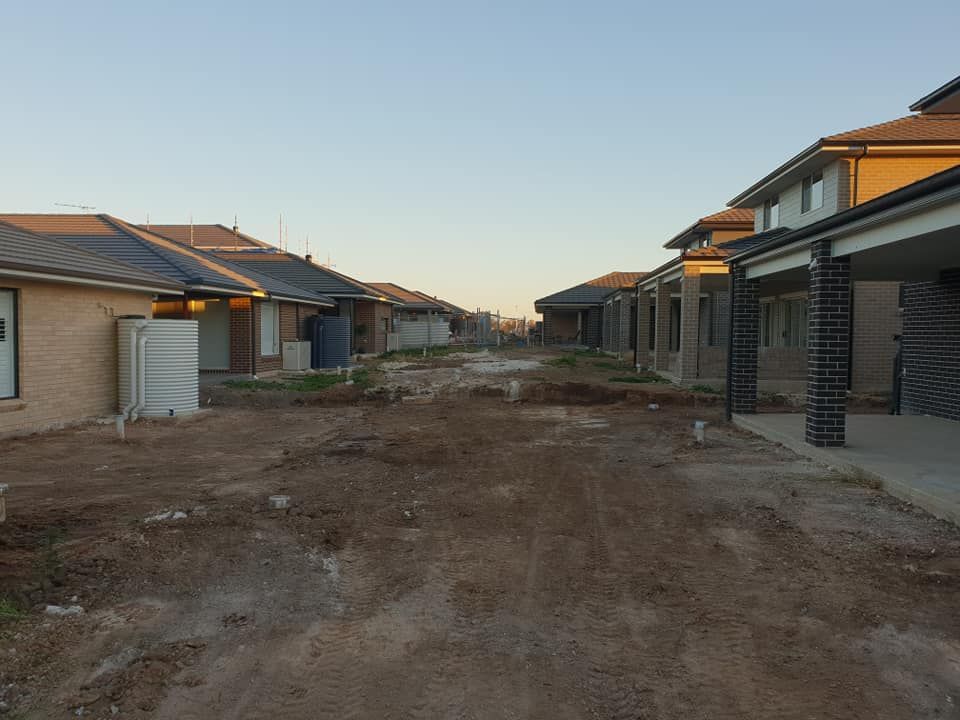 A row of houses are being built in a residential area