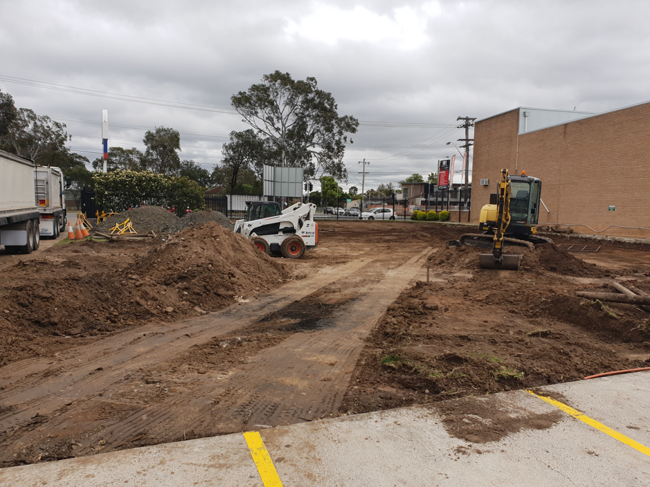 A construction site with a bulldozer in the middle of it