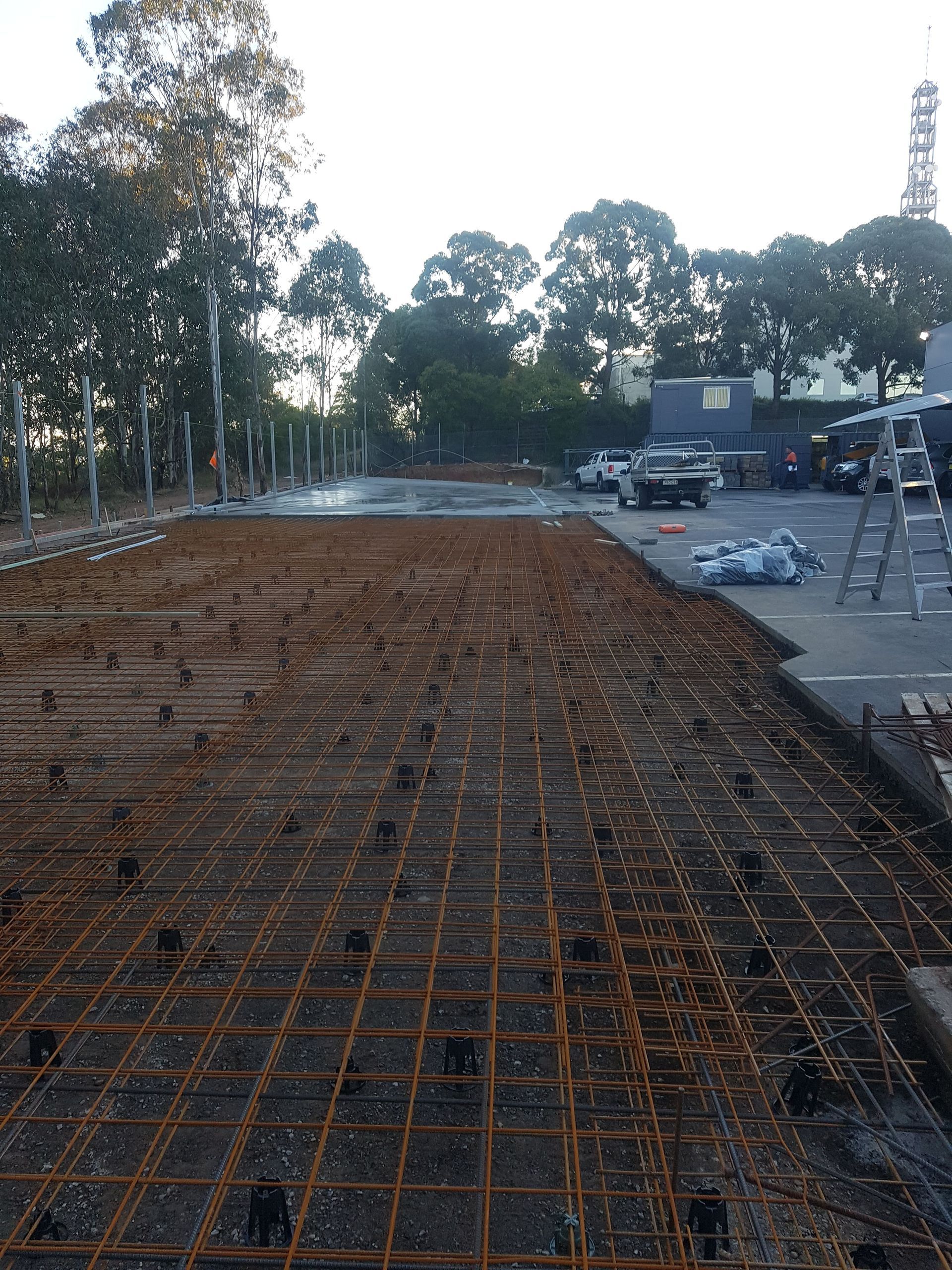 A construction site with a lot of steel bars on the ground