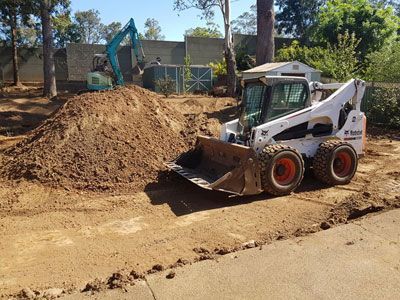 A bulldozer is moving dirt on a construction site.