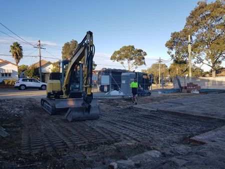 An excavator is moving dirt on a construction site.