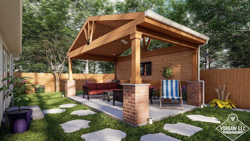 A backyard with a wooden gazebo and a brick patio.
