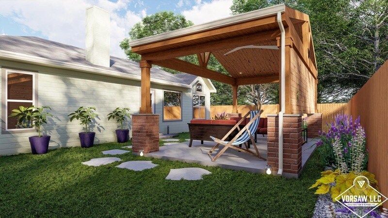 A woman is sitting in a chair under a wooden pavilion in a backyard.