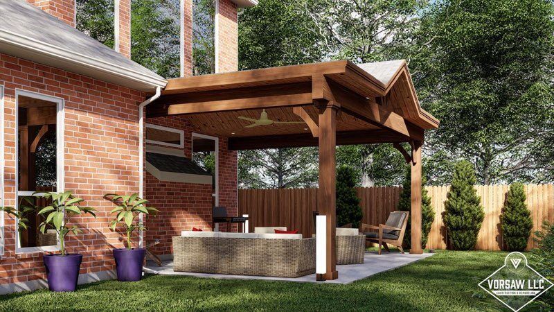 A brick house with a wooden pavilion in the backyard.