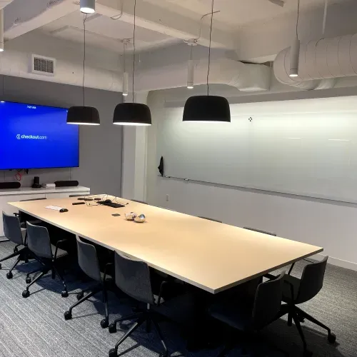 A conference room with a long table and chairs