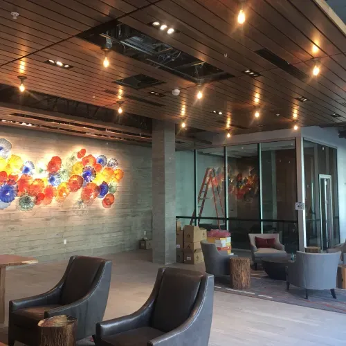 A room with chairs and a painting on the wall