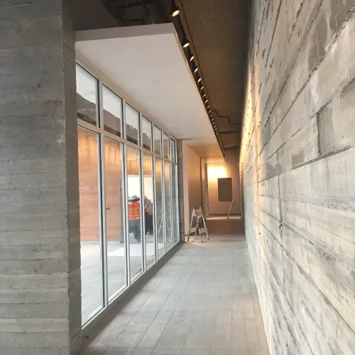 A long hallway in a building with a lot of windows