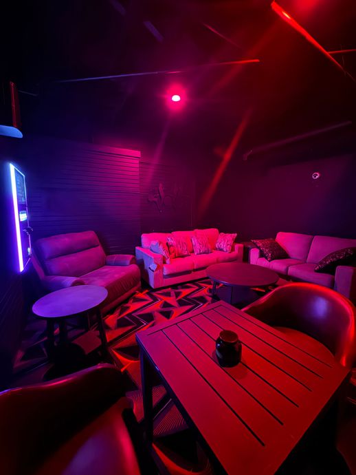 A living room with a couch , chairs , tables and a table.